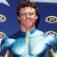 Placeholder: A superhero man with a sky blue spandex suit. He has a sky blue mask on, blue eyes, freckles, dimples, and curly dark brown hair. He's wearing gold boots and gold artist gloves with a white belt and has a gold M on his chest. His boots have small feathered wings on them, and his shoulders have shoulder pads. He is smiling