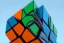 Placeholder:  tall Rubik's Cube skyscrapers, Orange, white, blue, green