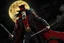 Placeholder: Still frame of Tom Hiddleston as Alucard from the live action "Hellsing" movie based on the anime of the same name. He is wearing his signature red hat and yellow glasses, while laughing in the moonlight.