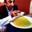 Placeholder: Zemmour, in jellaba, eating couscous