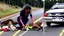 Placeholder: upset lady tries to revive deer on the highway using CPR or Mouth to Mouth