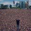 Placeholder: one man on stage in front of massive crowd