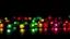 Placeholder: Defocused multi colored lights on a black background.