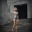 Placeholder: beautiful anorexic woman, total shot, short grey metallic triathlon swimsuit, short blond wavy bob hair, blurred concrete background
