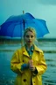 Placeholder: In the music video, a 23-year-old woman with blonde hair and bright blue eyes stands in the sea, dressed in a yellow fisherman's jacket. She holds an umbrella, but it offers no protection from the pouring rain. Around her, seahorses are moving. The rain is pouring heavily. She is standing in the middle of the sea