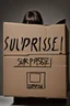 Placeholder: Cardboard box in a dark room with "surprise" on the front surface and the top flaps slightly lifted and a clawed hand just visible