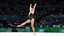Placeholder: Please provide a detailed Photo of a female gymnast performing her routine on the floor exercise at the Olympic Games. Include specific elements of her performance, such as her choreography, the difficulty of her moves, her artistry, and how she engages the audience. Additionally, describe the atmosphere of the event, the reactions of the crowd, and any notable aspects of her presentation. The output should be structured in a way that captures the excitement and technical skill of the performanc