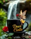 Placeholder: photorealism surrealistic image of a big black shiny coffee cup with steam, a beautiful fairy sitting near the cup and holding a red rose,and the text 'Dewi Cinta' in a trendy font. Add a golden heart with the word 'Dewi Cinta' written on it to enhance the love atmosphere. lush blurred background green waterfall greenery, ultra HD 64k studio hyperrealism lightning light reflection macro photography sharp focus