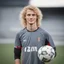 Placeholder: 85mm DSLR colour photography of a very detailed headshot fitting all of head and hair in frame. 22year old Germen soccer player, with blonde hair color and no facial hair and has long curly hair with a small smile, grey background