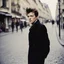 Placeholder: Color picture in the Streets of Paris: Biographie, photographie et citations de Arthur Rimbaud. Jean Nicolas Arthur Rimbaud est un poète français (with a messy hairdo,)