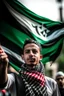 Placeholder: A young man stands and holds a large Palestinian flag in his hands and waves it while wearing a keffiyeh