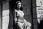 Placeholder: [photo by helmut newton in agent provocateur on the arena] Her complexion, after years spent training under the sun, bore the mark of a warrior who had weathered countless battles. Though her face spoke of hardship, there was also an air of grace and serenity that emanated from her every pore. Selene's physique was a testament to her dedication and discipline. Her muscular frame hinted at her physical prowess, yet her movements were fluid, as if she danced with the wind itself.