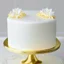 Placeholder: A picture of a simple white cake with golden decoration