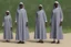 Placeholder: 4 suore africane con tunica grigia figura intera fino ai piedi