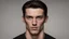 Placeholder: Fair skinned male, square head and jaw, dark brown hair that stands up slightly, tall and well built, pitch black eyes