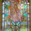 Placeholder: A big Art Nouveau stained-glass window in an Art Nouveau villa by artist "Alphonse Mucha"