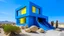 Placeholder: A modern blue building with a large window and a raised platform in the foreground made of yellow rocks or sand