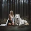 Placeholder: Beautiful young woman kneeling in front of a large white alpha wolf