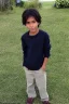 Placeholder: Appearance: Ari has a mixed-race skin tone with a light brown complexion. He has dark hair in a page boy haircut, and his hair length could be somewhere in-between long and short. His face is thin with high cheekbones and dark eyes that are often full of emotion. He stands at around 5 feet 7 inches tall, with a lean build that suggests he doesn't engage in a lot of physical activity. He is of average attractiveness with a boyish face.