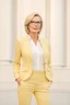Placeholder: Powerful classical portrait of a modern blonde politician with glasses in her mid 40s wearing a pastel yellow pant suit standing in a elegant position