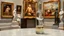 Placeholder: a pretty glass wine jar with beautiful minature glass shapes on out side and some glass hlalf sphere on it with a lady ballerina inside in pretty standing ballet pose on a table in a art gallery with famouse paintings and statues