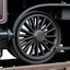 Placeholder: isolated image of a spoked steel wheel(black) from a steam train. vignette of just the wheel