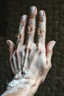 Placeholder: A big hand of a giant human textured with white powder and muddy skin with cracks and corrosion