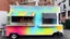 Placeholder: modern looking food truck that has a bunch of bright paint and flashy lights and fireworks