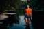 Placeholder: beautiful girl in blue short and orange top walking in water toward camera in trees next to wavy river with clear water and nice sands in floor.camera capture from her full body front