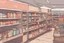 Placeholder: can you please generate an image of supermarket in a refugee camp that sells imported goods like clothes, bottled water, cleaning products ect