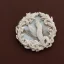 Placeholder: ivory brooch of a kingfisher, decorative design, classical ornament, highly ornate, highly intricate, highly detailed etching, marble carving, warm lighting, linen backdrop