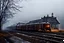 Placeholder: An old vintage train station on a foggy day, add deep dark color and reflections in and around the old stempunk train