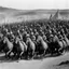 Placeholder: [very impressive high res masterpiece in Kodak Eastman 5247, scene by László Krasznahorkai] On reaching it the chariots were parked with military precision on the four sides of the enclosure, and half a score of warriors, headed by the enormous chieftain, and including Tars Tarkas and several other lesser chiefs, dismounted and advanced toward it. | could see Tars Tarkas explaining something to the principal chieftain, whose name, by the way, was, as nearly as | can translate it into English, Lo