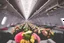 Placeholder: A symmetrical view of an airplane compartment filled with boxes of flowers