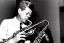 Placeholder: Lonely John f kennedy playing A normal saxophone with his eyes closed