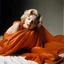 Placeholder: A photograph of marilyn monroe inthe style of milton greene, orange silk sheet, white background