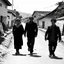 Placeholder: People in 1995 walking on a street in a village, black and white, very odd