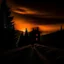 Placeholder: dark night, orange sunset colors in the sky, a lonely cabin in the distance on a mountain in the woods, a lonely dark silhouette walking down the road