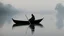 Placeholder: black robed monk in a small boat on quiet water in the mist