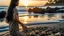 Placeholder: A serene beach at sunset in Bali: an Indonesian woman with long black hair, wearing a batik sarong, walks along the shore, collecting seashells.