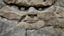 Placeholder: face in the rock wall mountain