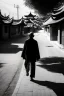 Placeholder: Black & white man walks on road's chinese village with playing light and shadow as ho fan style