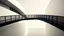 Placeholder: Elevated walkway of dark steel winding between white volumes, long shadows creating rhythm and a pale, nearly desaturated sky, analog architectural photography style.
