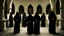 Placeholder: black robe hooded monks in the chapel