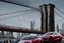 Placeholder: A Tesla's 'Model 3' is parked, on the 'Brooklyn Bridge' in New York. CINEMATIC. WIDE ANGLE LENS. PHOTO REAL.