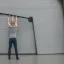 Placeholder: skinny guy lifting garage door on a rainy day