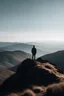 Placeholder: A man standing in the distance on top of a mountain looking out in the distance