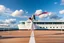 Placeholder: a ballerina dncing in deck of a modern big ship ,in oceion water vaves pretty blue sky with clouds
