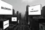 Placeholder: greyscale cityscape upshot: minimalism, many large white billboards populate the city with black block lettering with single word choose randomly between: "BIOMORPH" || "CB" || "SPATCHCOCK" || "TANGUY", || "SURREAL". || 'They Live' movie still, city panoramic, concept art, subliminal messaging