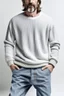 Placeholder: Man's wide leg light jeans and a half knitted jumper on a white t-shirt